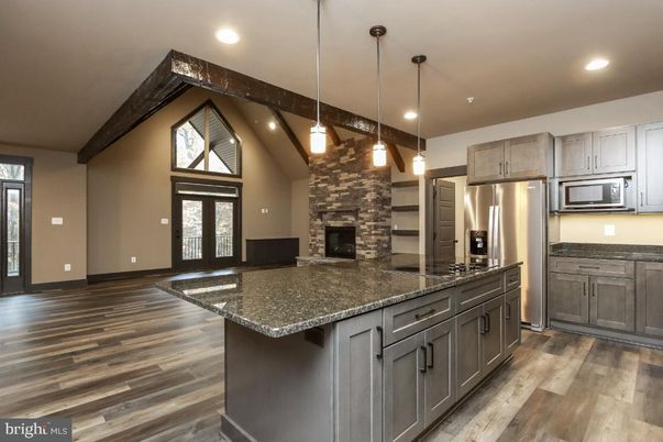 Fireplace, Interior, Kitchen, Pendant Lights, Recessed Lighting, Stainless Steel Appliances, Stone Walls, Wooden Beams, Wood Texture Flooring