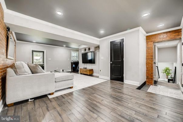 Fireplace, Interior, Living room, Recessed Lighting, Stone Walls, Wood Texture Flooring