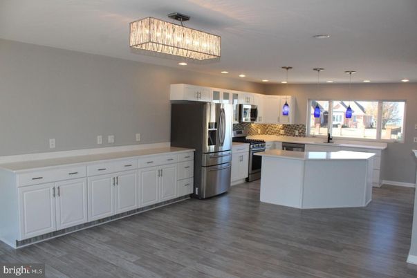 Chandelier, Interior, Kitchen, Pendant Lights, Recessed Lighting, Stainless Steel Appliances, Wood Texture Flooring