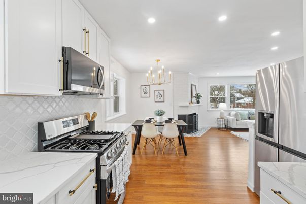 Chandelier, Dining room, Fireplace, Interior, Kitchen, Living room, Recessed Lighting, Stainless Steel Appliances, Wood Texture Flooring