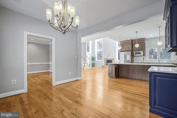 Chandelier, Empty room, Fireplace, Interior, Kitchen, Pendant Lights, Recessed Lighting, Wood Texture Flooring