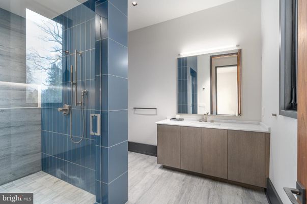 Bathroom, Dual Sink Vanities, Glass Shower, Interior, Marble Walls, Recessed Lighting, Wood Texture Flooring