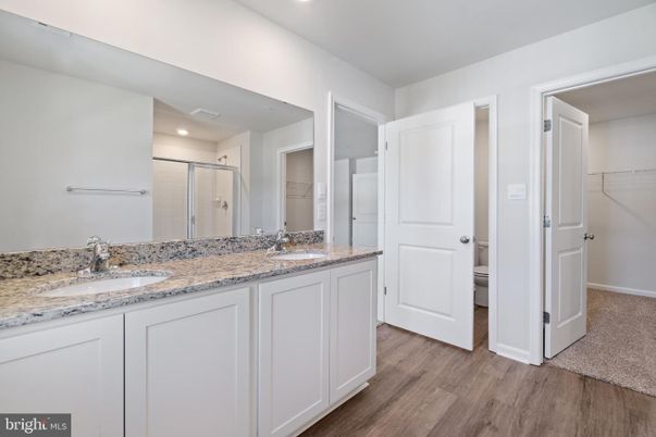Bathroom, Dual Sink Vanities, Interior, Recessed Lighting, Wood Texture Flooring