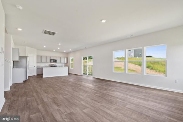 Empty room, Interior, Kitchen, Recessed Lighting, Stainless Steel Appliances, Wood Texture Flooring