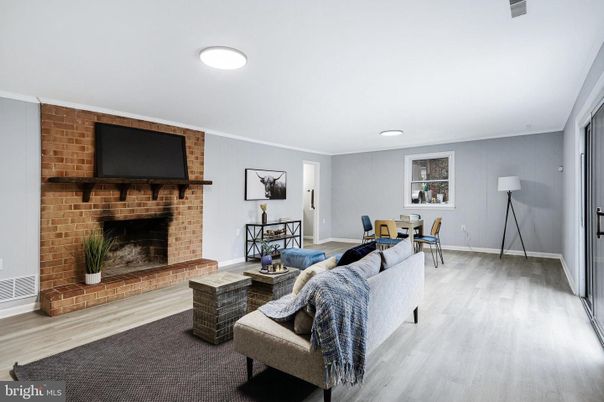Dining room, Fireplace, Interior, Living room, Recessed Lighting, Stone Walls, Wood Texture Flooring