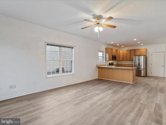 Empty room, Interior, Kitchen, Recessed Lighting, Stainless Steel Appliances, Wood Texture Flooring