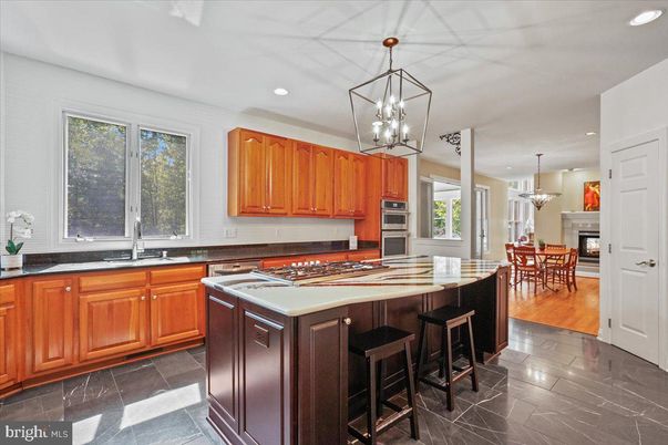 Chandelier, Dining room, Interior, Kitchen, Pendant Lights, Recessed Lighting, Stainless Steel Appliances, Wood Texture Flooring