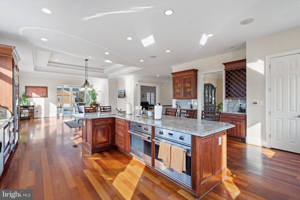 Chandelier, Dining room, Interior, Kitchen, Pendant Lights, Recessed Lighting, Stainless Steel Appliances, Wood Texture Flooring