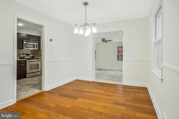 Empty room, Interior, Kitchen, Pendant Lights, Recessed Lighting, Stainless Steel Appliances, Wood Texture Flooring