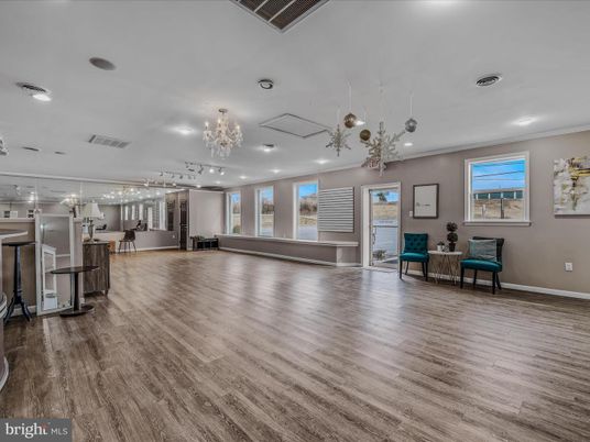 Chandelier, Empty room, Interior, Kitchen, Pendant Lights, Recessed Lighting, Stainless Steel Appliances, Wood Texture Flooring