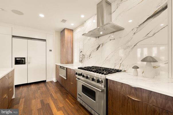 Interior, Kitchen, Marble Walls, Recessed Lighting, Stainless Steel Appliances, Wood Texture Flooring