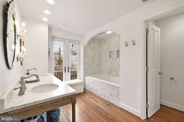 Bathroom, Dual Sink Vanities, Interior, Marble Walls, Recessed Lighting, Wood Texture Flooring