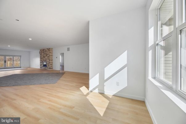 Empty room, Fireplace, Interior, Recessed Lighting, Stone Walls, Wood Texture Flooring