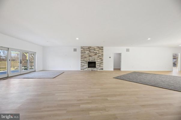 Empty room, Fireplace, Interior, Recessed Lighting, Stone Walls, Wood Texture Flooring