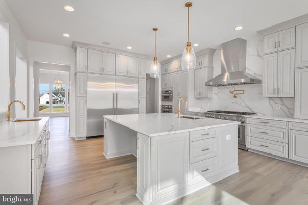 Interior, Kitchen, Marble Walls, Pendant Lights, Recessed Lighting, Stainless Steel Appliances, Wood Texture Flooring