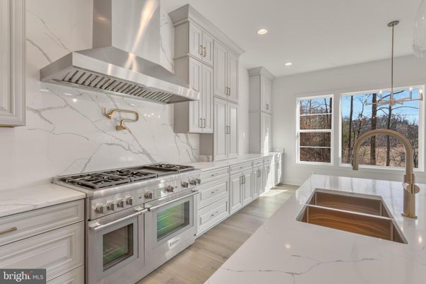 Interior, Kitchen, Marble Walls, Recessed Lighting, Stainless Steel Appliances, Wood Texture Flooring
