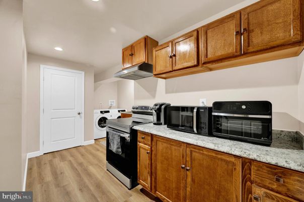 Interior, Kitchen, Recessed Lighting, Washer, Wood Texture Flooring