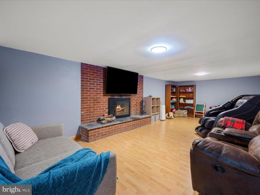 Fireplace, Interior, Living room, Recessed Lighting, Stone Walls, Wood Texture Flooring