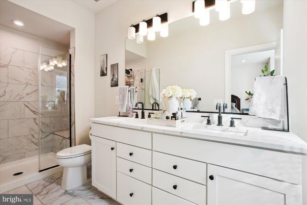 Bathroom, Dual Sink Vanities, Glass Shower, Interior, Marble, Marble Walls, Recessed Lighting, Tile Countertops