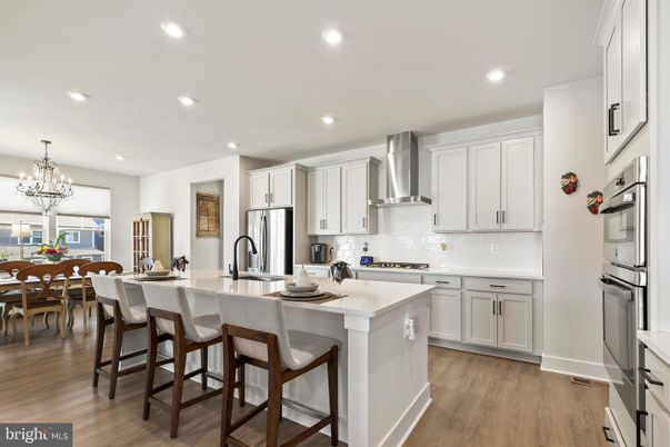 Chandelier, Dining room, Interior, Kitchen, Recessed Lighting, Stainless Steel Appliances, Wood Texture Flooring