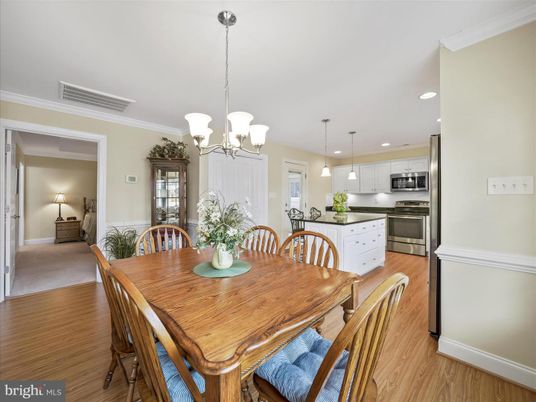 Chandelier, Dining room, Interior, Kitchen, Pendant Lights, Recessed Lighting, Stainless Steel Appliances, Wood Texture Flooring