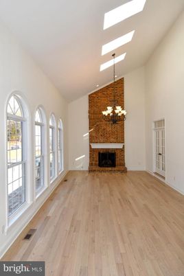 Chandelier, Empty room, Fireplace, Interior, Recessed Lighting, Stone Walls, Wood Texture Flooring