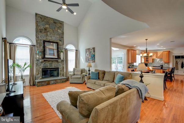Fireplace, Interior, Kitchen, Living room, Pendant Lights, Recessed Lighting, Stainless Steel Appliances, Stone Walls, Wood Texture Flooring