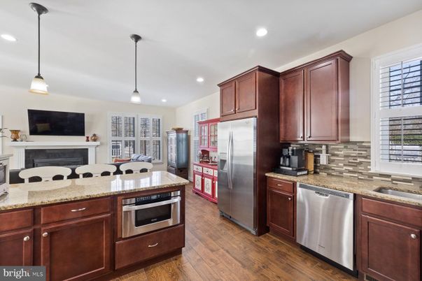 Fireplace, Interior, Kitchen, Pendant Lights, Recessed Lighting, Stainless Steel Appliances, Wood Texture Flooring