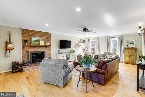 Fireplace, Interior, Living room, Recessed Lighting, Stone Walls, Wood Texture Flooring