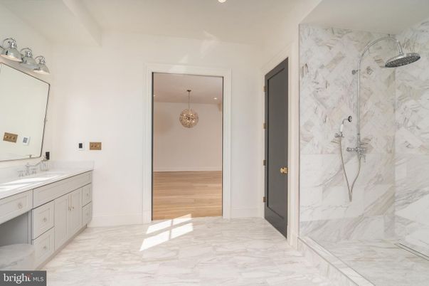Bathroom, Chandelier, Dual Sink Vanities, Interior, Marble, Marble Walls, Recessed Lighting, Wood Texture Flooring