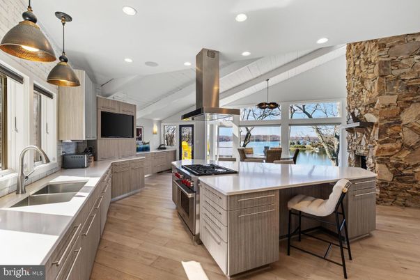 Fireplace, Interior, Kitchen, Pendant Lights, Recessed Lighting, Stainless Steel Appliances, Stone Walls, Wood Texture Flooring