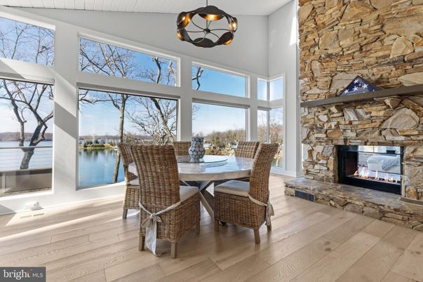 Dining room, Fireplace, Interior, Pendant Lights, Stone Walls, Water, Wood Texture Flooring
