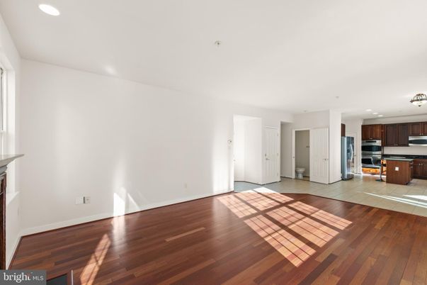 Empty room, Interior, Kitchen, Recessed Lighting, Stainless Steel Appliances, Wood Texture Flooring
