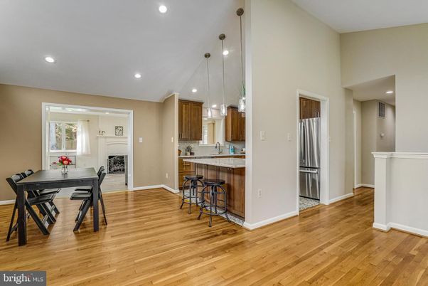 Dining room, Fireplace, Interior, Kitchen, Pendant Lights, Recessed Lighting, Stainless Steel Appliances, Wood Texture Flooring