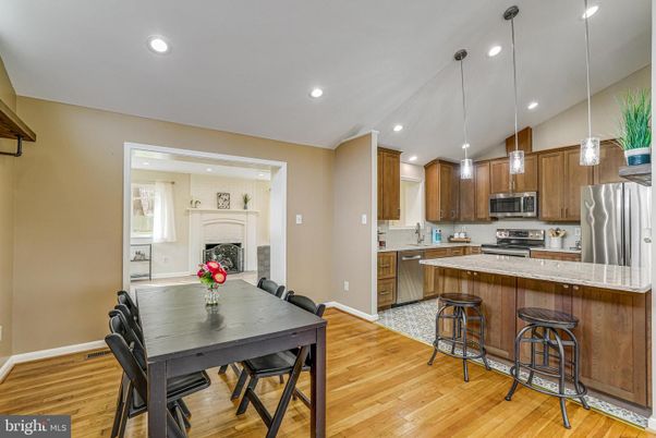 Dining room, Fireplace, Interior, Kitchen, Pendant Lights, Recessed Lighting, Stainless Steel Appliances, Wood Texture Flooring