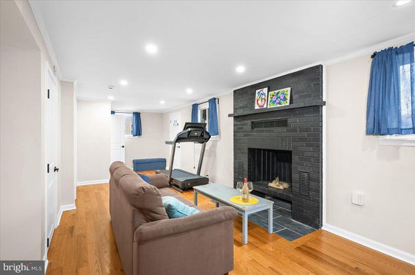 Fireplace, Fitness Equipment, Interior, Living room, Recessed Lighting, Wood Texture Flooring