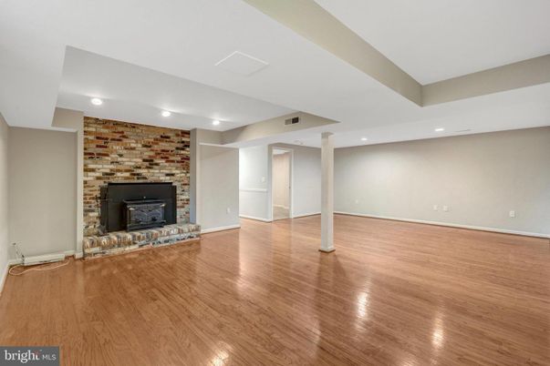 Empty room, Fireplace, Interior, Recessed Lighting, Stone Walls, Wood Texture Flooring