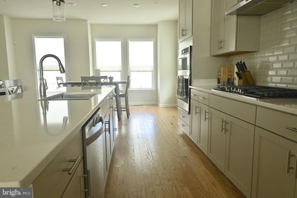 Dining room, Interior, Kitchen, Recessed Lighting, Stainless Steel Appliances, Wood Texture Flooring