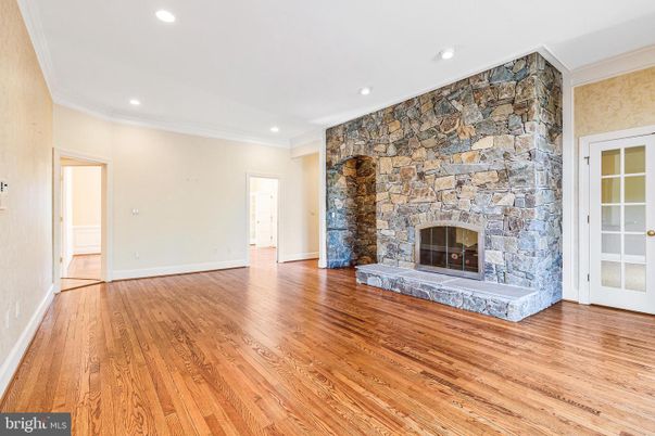 Empty room, Fireplace, Interior, Recessed Lighting, Stone Walls, Wood Texture Flooring