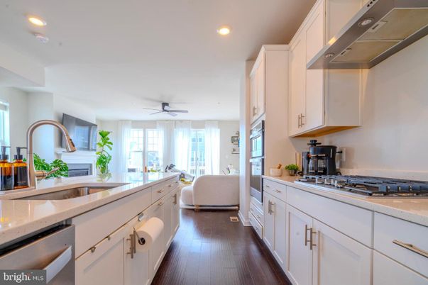 Fireplace, Interior, Kitchen, Recessed Lighting, Stainless Steel Appliances, Wood Texture Flooring