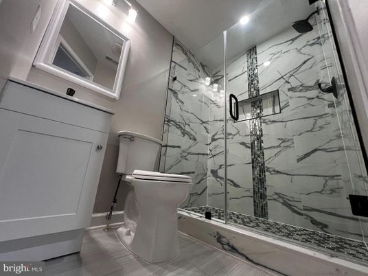 Bathroom, Glass Shower, Interior, Marble Walls, Recessed Lighting, Wood Texture Flooring