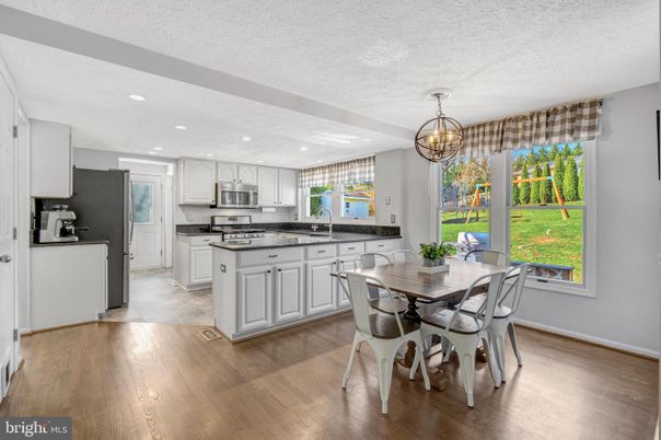 Chandelier, Dining room, Interior, Kitchen, Recessed Lighting, Stainless Steel Appliances, Wood Texture Flooring