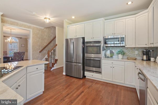 Chandelier, Dining room, Interior, Kitchen, Recessed Lighting, Stainless Steel Appliances, Wood Texture Flooring