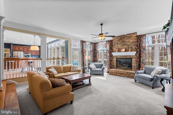 Fireplace, Interior, Kitchen, Living room, Pendant Lights, Recessed Lighting, Stainless Steel Appliances, Stone Walls, Wood Texture Flooring