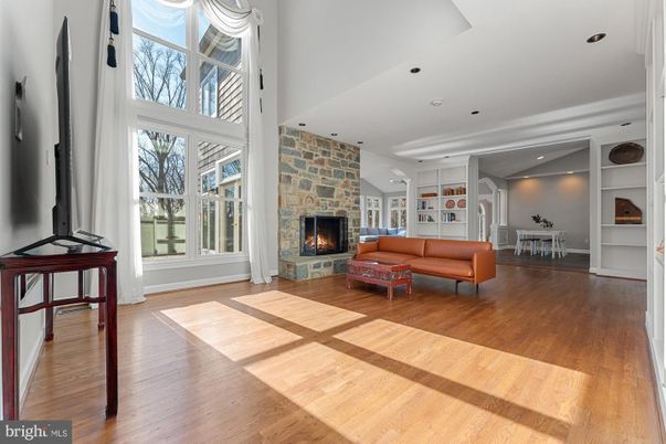 Dining room, Fireplace, Interior, Living room, Recessed Lighting, Stone Walls, Wood Texture Flooring