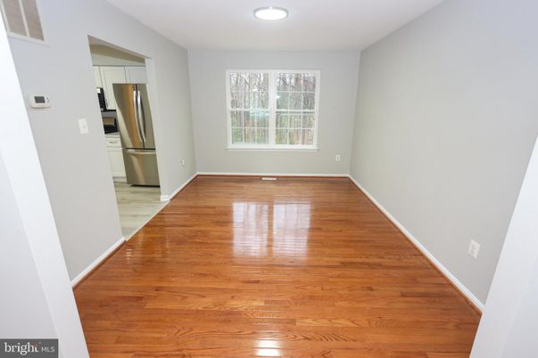 Empty room, Interior, Kitchen, Recessed Lighting, Stainless Steel Appliances, Wood Texture Flooring