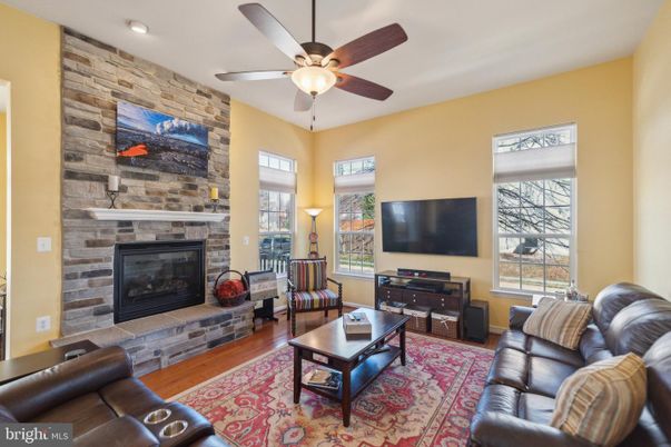 Fireplace, Interior, Living room, Recessed Lighting, Stone Walls, Wood Texture Flooring