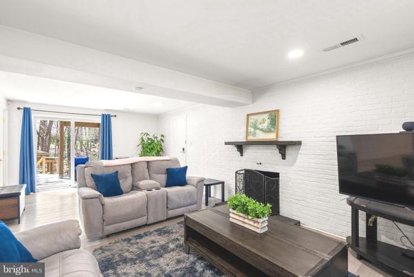 Fireplace, Interior, Living room, Recessed Lighting, Stone Walls, Wood Texture Flooring