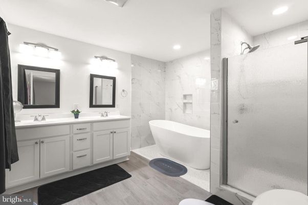 Bathroom, Dual Sink Vanities, Free Standing Baths, Glass Shower, Interior, Marble Walls, Recessed Lighting, Wood Texture Flooring