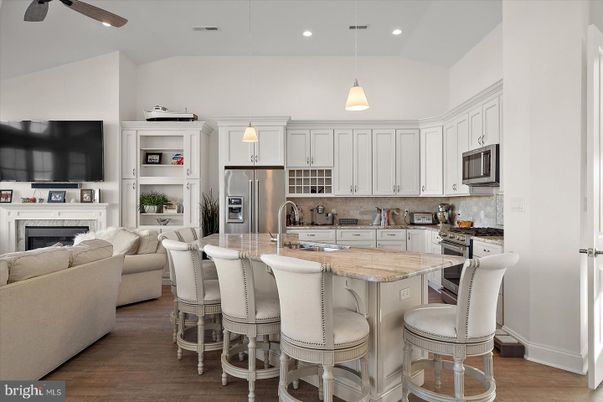 Fireplace, Interior, Kitchen, Living room, Pendant Lights, Recessed Lighting, Stainless Steel Appliances, Wood Texture Flooring
